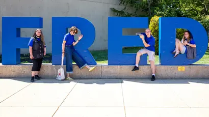 Students standing in front of the FRED letters at Williams Center