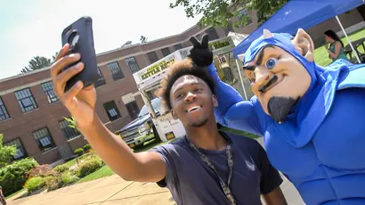 Fredonia students, like the one here posing with the mascot, should pay close attention to their financial aid decisions. 