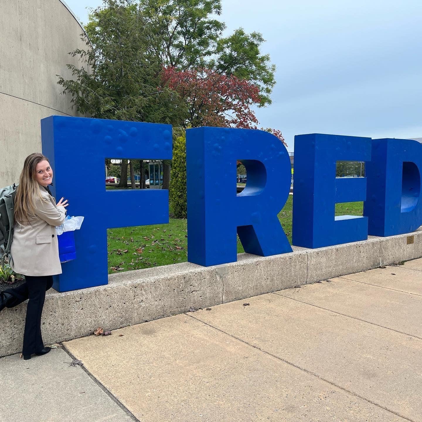 Rachel Archambault infront of Fred sign