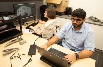 At work on the 3D skull project in the Houghton Hall Room 233 are Fiona Rigney (center) and Ishaan Prathamesh Rangnekar.