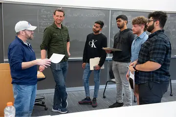 Joe Piacente and Ted Wojcik (far right) meet with Computer Science students following their informal presentation about careers in computer