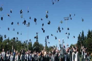 hats tossed into the air at commencement ceremony